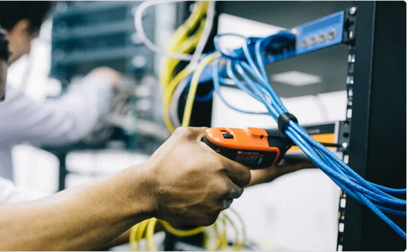 Technician configuring office network hardware